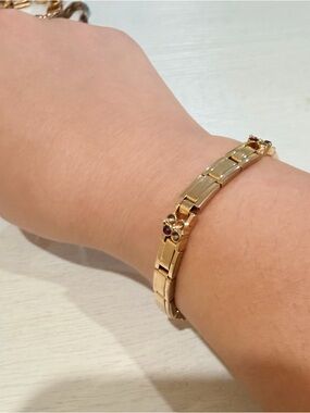 Gold tone Link Bracelet with Floral Accent